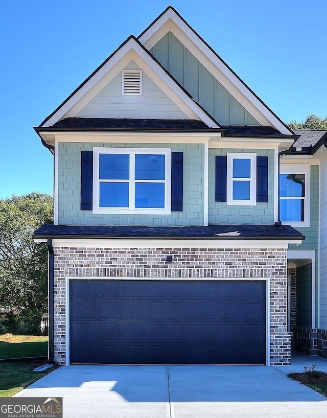 view of front facade featuring board and batten siding, concrete driveway, and an attached garage