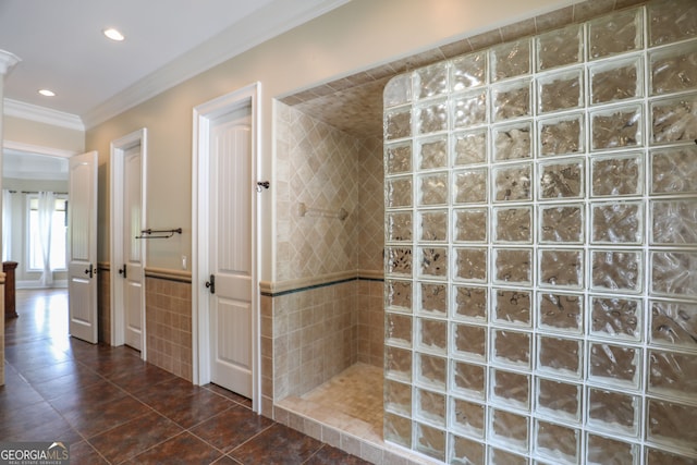 bathroom with tiled shower, ornamental molding, and tile patterned floors