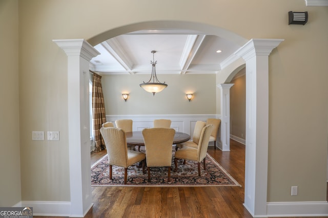 dining room with decorative columns, beamed ceiling, dark hardwood / wood-style flooring, and crown molding