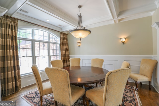 dining space featuring ornamental molding, beam ceiling, coffered ceiling, and dark hardwood / wood-style floors