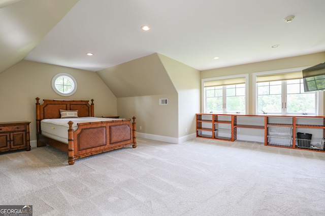 bedroom with light carpet and lofted ceiling