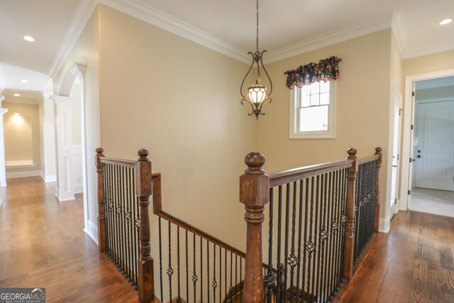 hall featuring dark wood-type flooring and crown molding