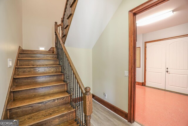 stairs featuring hardwood / wood-style flooring