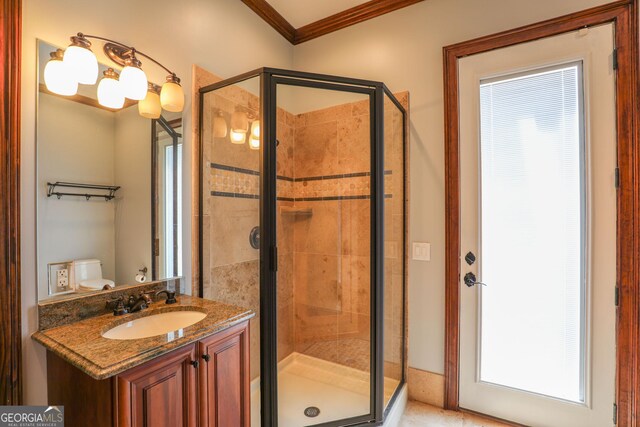 bathroom featuring an enclosed shower, vanity, crown molding, and toilet