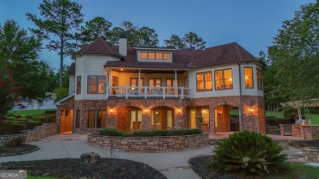 back of house with a balcony and a patio area