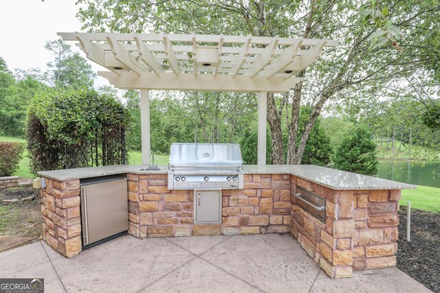 view of patio / terrace featuring area for grilling, exterior kitchen, and a pergola