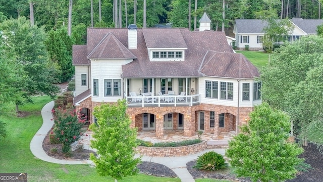 view of front facade with a balcony and a patio area