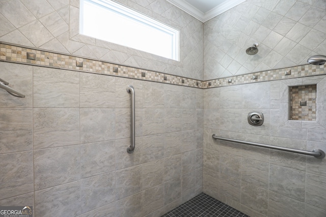 bathroom featuring tiled shower and ornamental molding