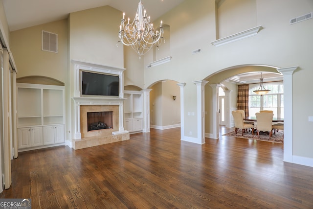 unfurnished living room featuring ornate columns, a premium fireplace, wood-type flooring, and high vaulted ceiling