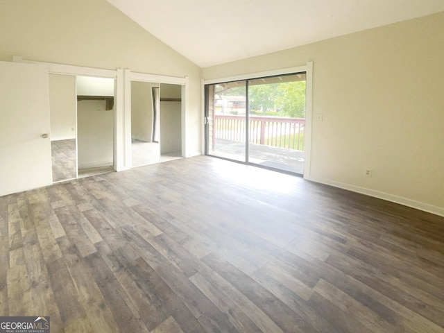 unfurnished bedroom featuring two closets, dark hardwood / wood-style floors, high vaulted ceiling, and access to outside