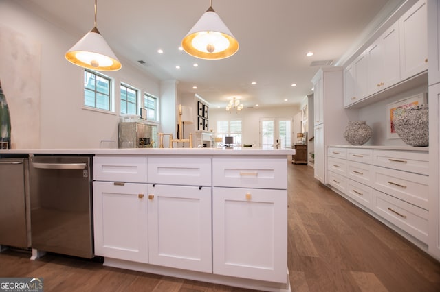 kitchen with stainless steel dishwasher, dark hardwood / wood-style flooring, and crown molding