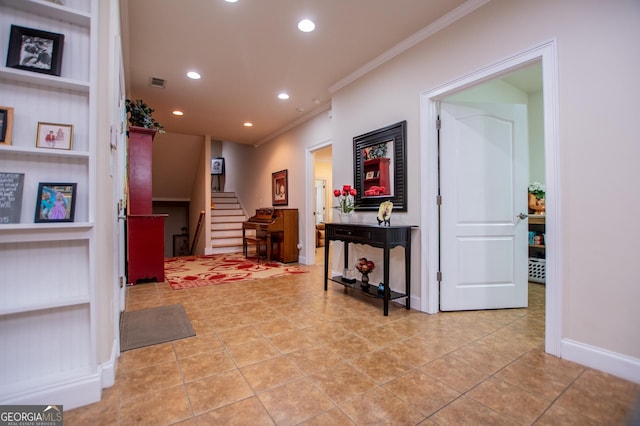 hall with crown molding, light tile patterned floors, and built in features