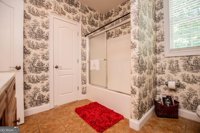 bathroom featuring bath / shower combo with glass door and tile patterned floors