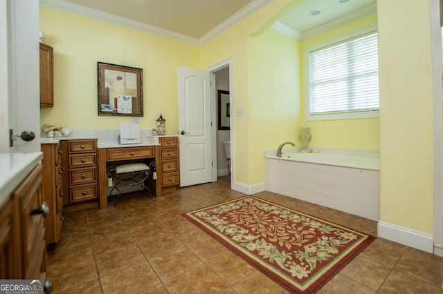 bathroom featuring tile patterned flooring, ornamental molding, vanity, and a bathtub