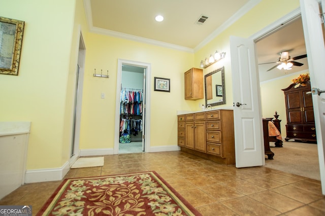 bathroom featuring crown molding, tile patterned floors, ceiling fan, and vanity