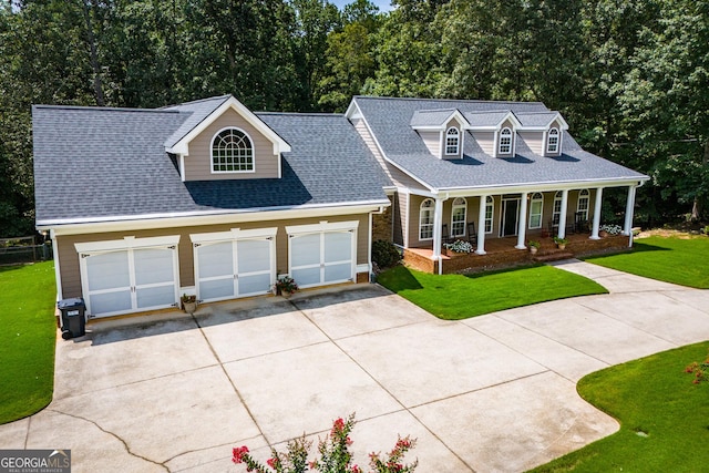 cape cod home with covered porch and a front lawn