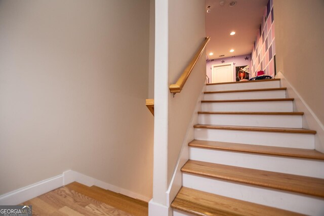 stairway featuring hardwood / wood-style flooring