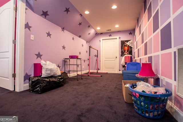 rec room featuring vaulted ceiling and dark colored carpet