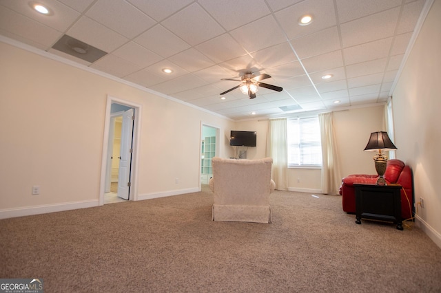 unfurnished room with ceiling fan, ornamental molding, a paneled ceiling, and carpet