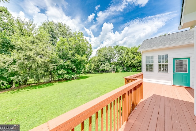 wooden deck featuring a lawn