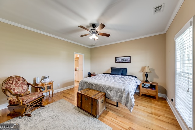 bedroom with light hardwood / wood-style floors, ornamental molding, ensuite bath, and ceiling fan