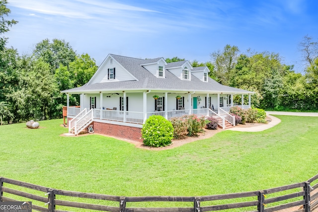 view of front of house with covered porch and a front yard