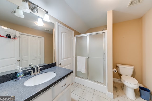 bathroom with vanity, tile patterned floors, a shower with door, and toilet