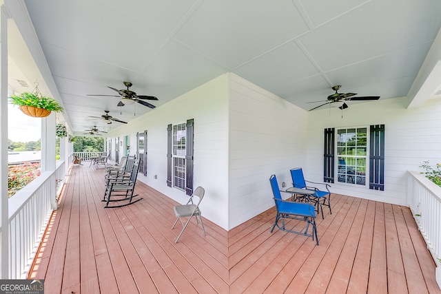 wooden terrace featuring ceiling fan