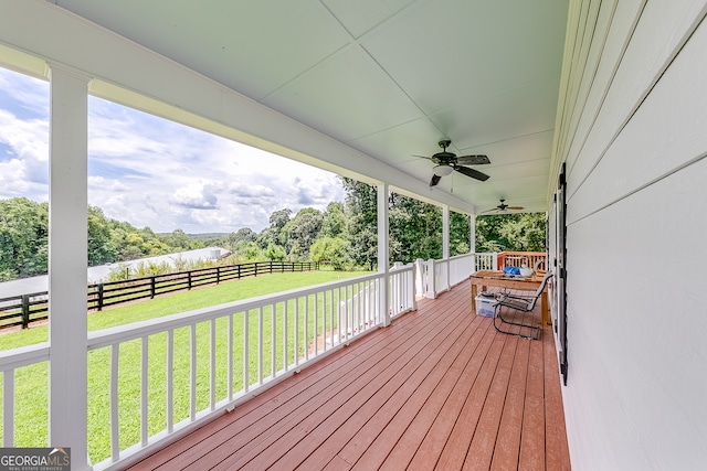 deck featuring a lawn and ceiling fan