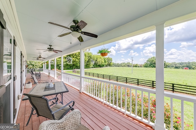 deck with ceiling fan and a lawn