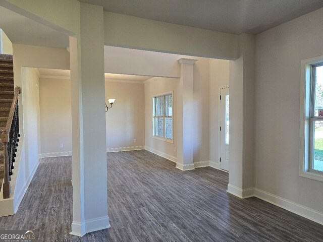 foyer entrance featuring an inviting chandelier, ornamental molding, and a high ceiling