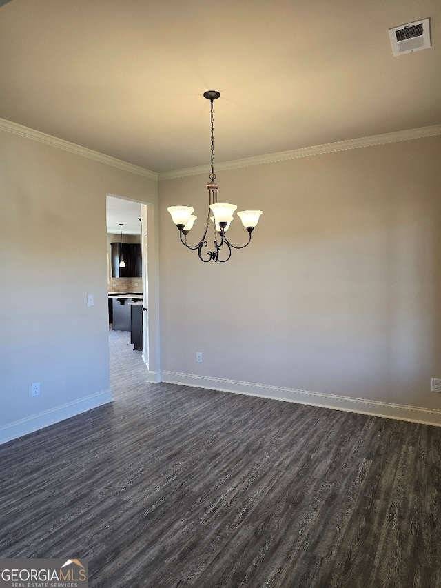 empty room with a chandelier, visible vents, dark wood finished floors, and baseboards