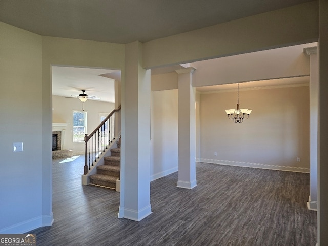 below grade area featuring dark wood-style floors, stairway, a fireplace, and baseboards