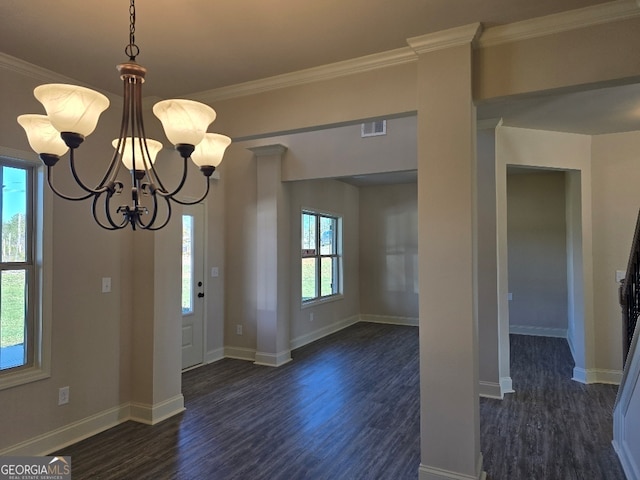 entrance foyer featuring a chandelier, dark wood-type flooring, visible vents, baseboards, and ornamental molding