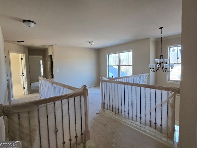 hall featuring an inviting chandelier and plenty of natural light