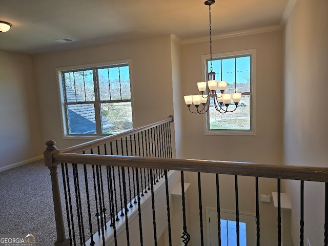 stairway with a notable chandelier, visible vents, baseboards, ornamental molding, and carpet