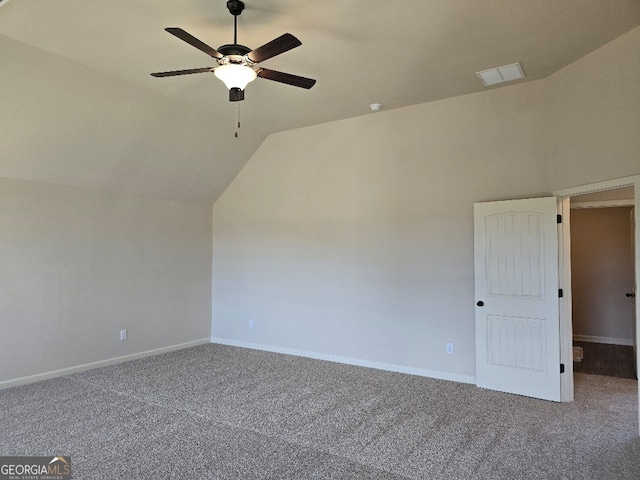 additional living space with carpet, visible vents, vaulted ceiling, and baseboards