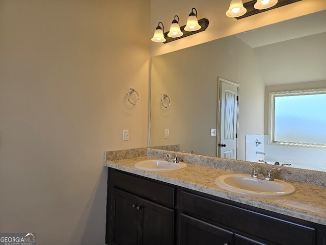 bathroom featuring double vanity, a bathtub, a sink, and lofted ceiling