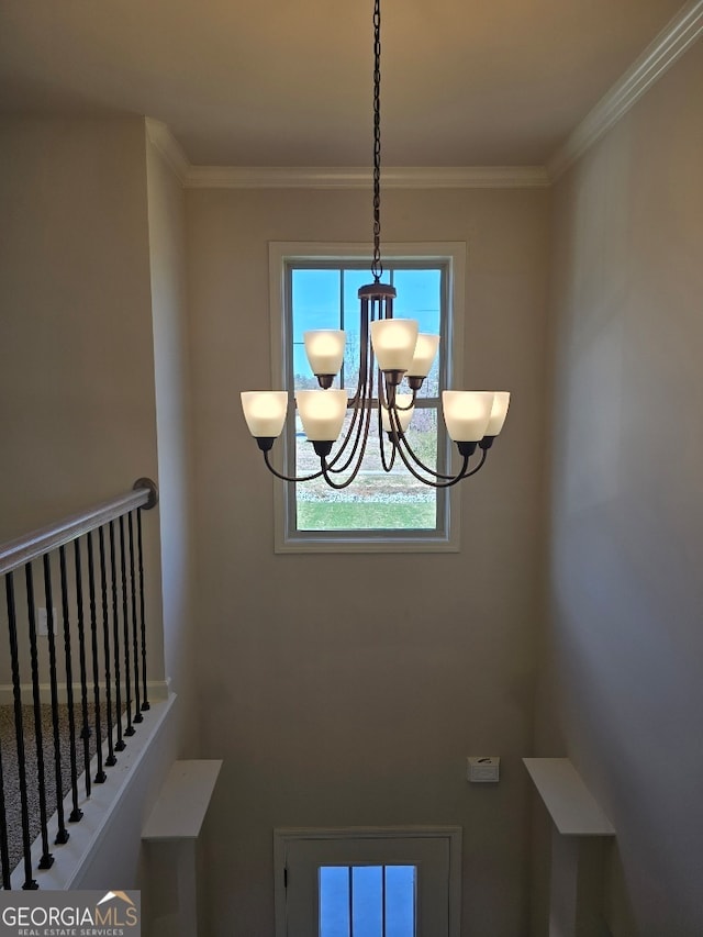 interior details featuring ornamental molding and an inviting chandelier