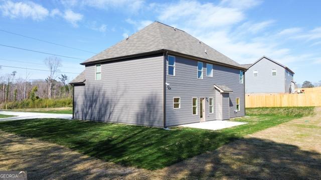 back of house featuring a patio area, fence, and a lawn