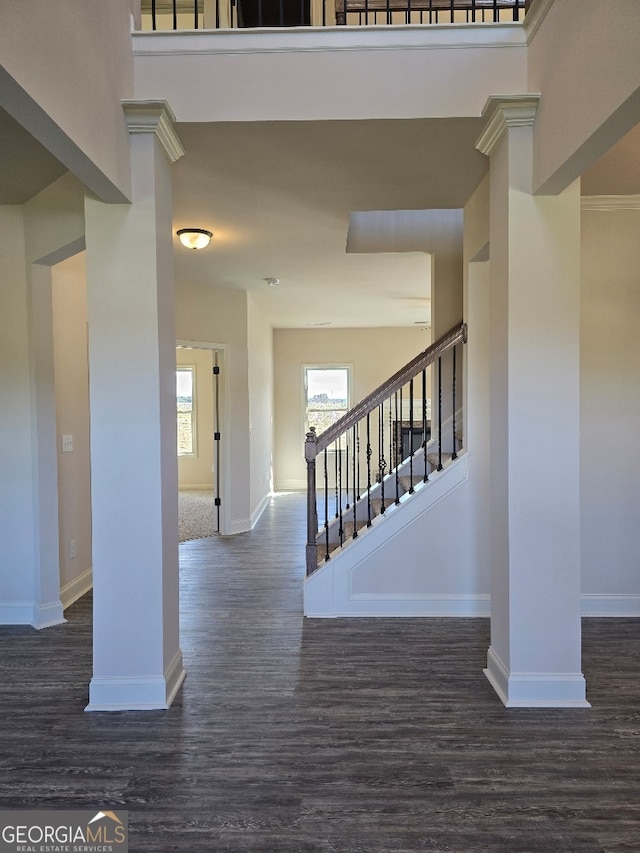 staircase with baseboards and wood finished floors