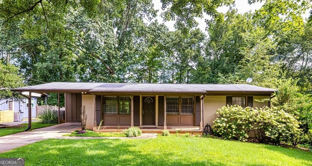 ranch-style house with a front yard and covered porch