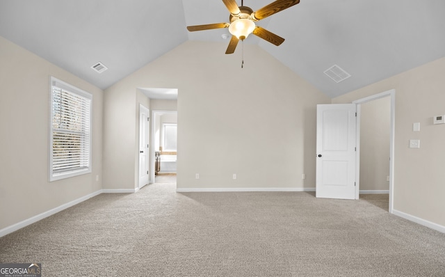 spare room with ceiling fan, light colored carpet, and high vaulted ceiling