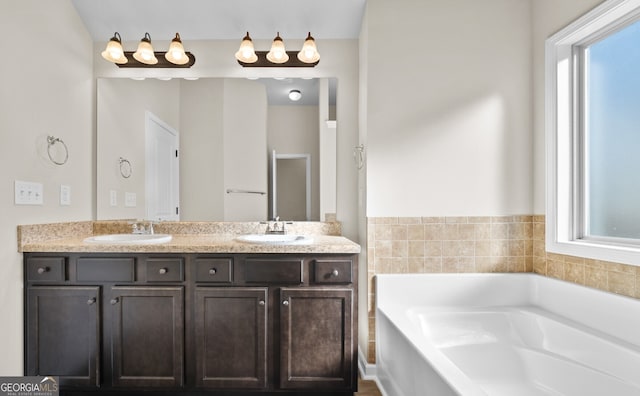 bathroom with vanity and a tub