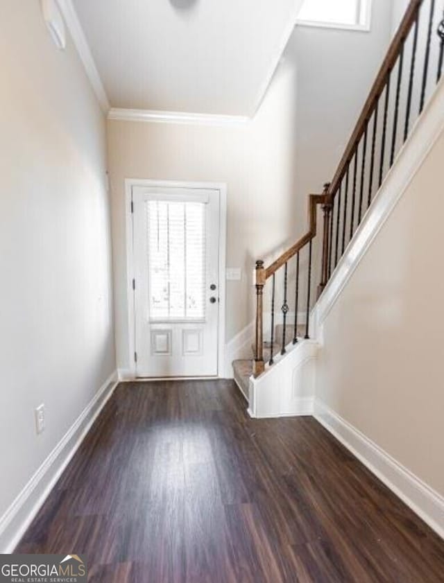 entrance foyer featuring dark hardwood / wood-style floors and crown molding