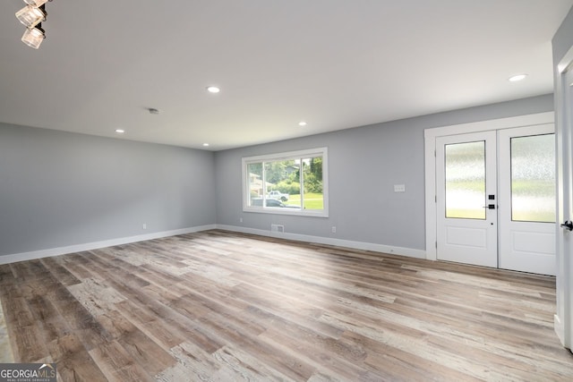 interior space with light hardwood / wood-style floors and french doors