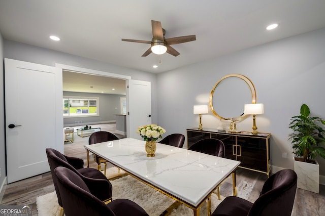 dining space with ceiling fan and hardwood / wood-style floors