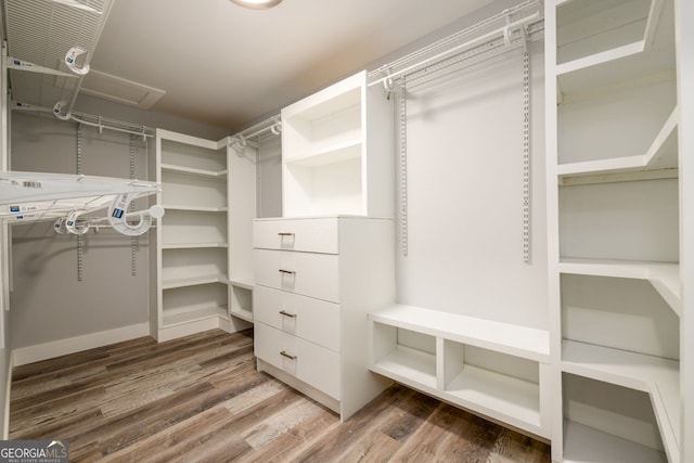 spacious closet with hardwood / wood-style floors