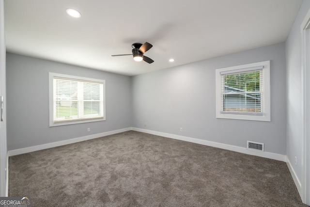 spare room featuring ceiling fan and carpet floors