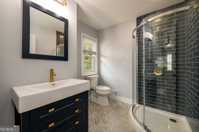 bathroom featuring toilet, an enclosed shower, and vanity